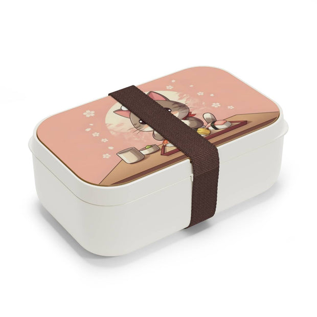 Bento box with a manga style design representing a cat eating sushi, side