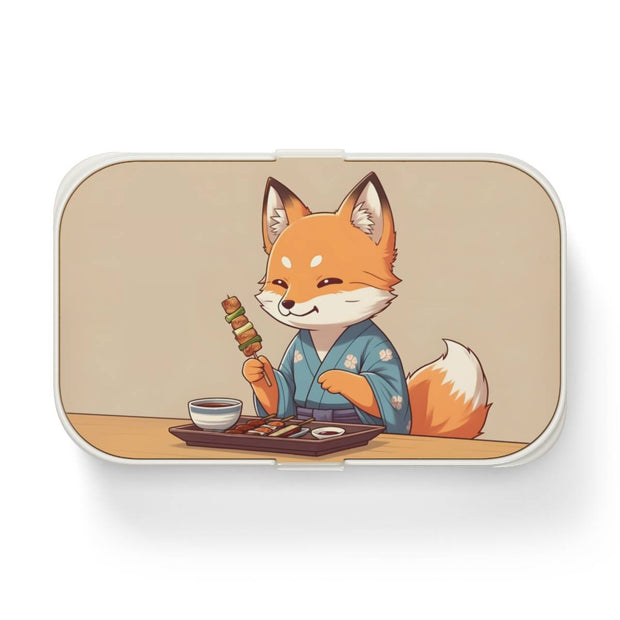 Bento box with a manga style design representing a fox eating yakitori, front