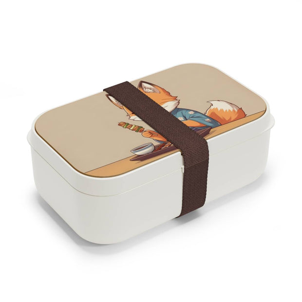 Bento box with a manga style design representing a fox eating yakitori, side