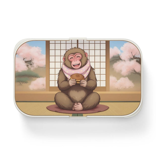 Bento box with a manga style design representing a macaque eating dorayaki, front