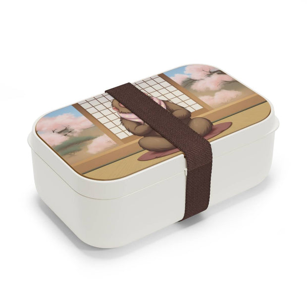 Bento box with a manga style design representing a macaque eating dorayaki, side