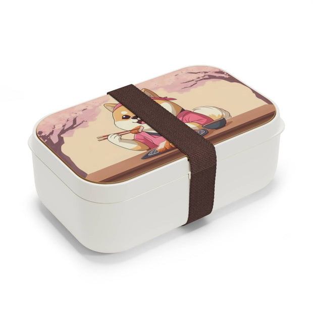 Bento box with a manga style design representing a Shiba Inu eating tonkatsu, side