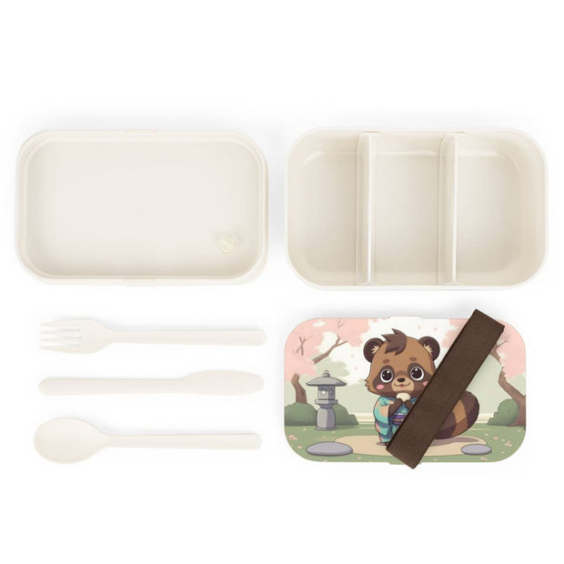 Bento box with a manga style design representing a tanuki eating mochi, components