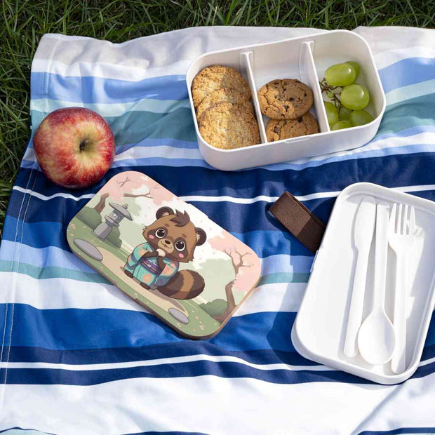 Bento box with a manga style design representing a tanuki eating mochi, lifestyle