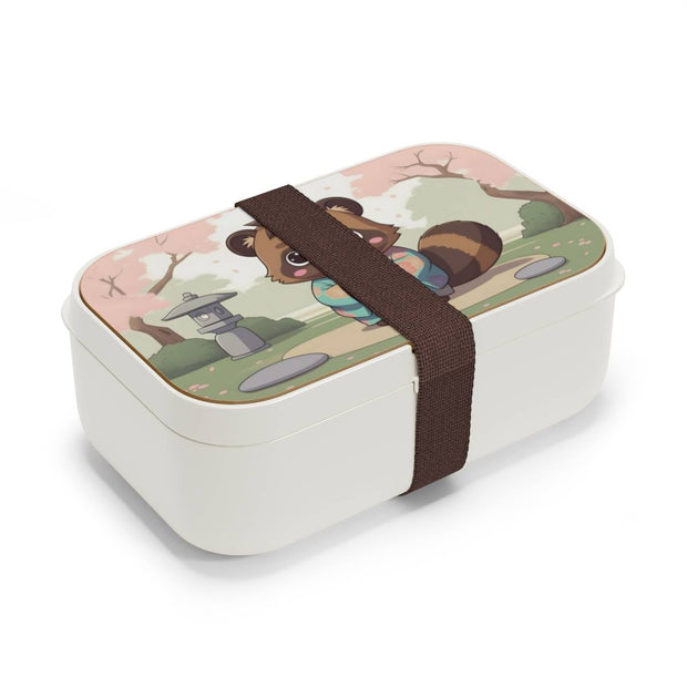 Bento box with a manga style design representing a tanuki eating mochi, side