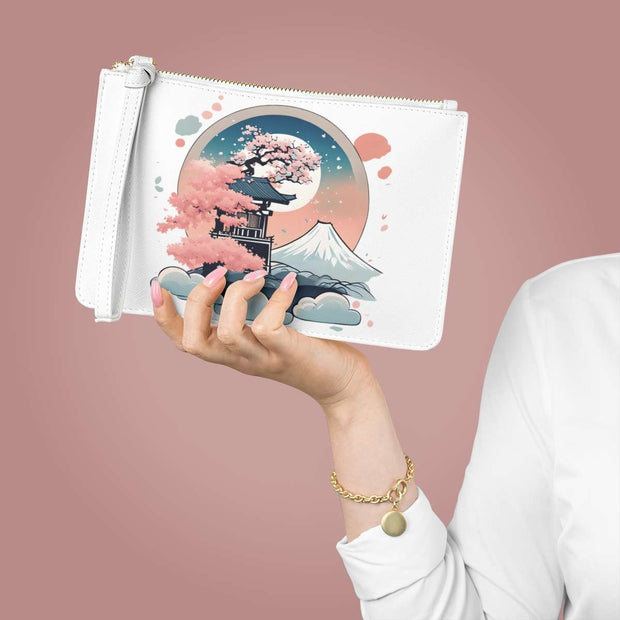 Clutch bag with a pastel design representing an enchanted place, hold in a hand