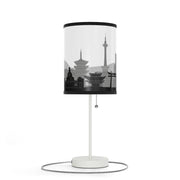 Lamp on a stand with Kyoto's skyline design, left