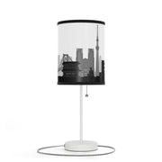 Lamp on a stand with Tokyo's skyline design, left